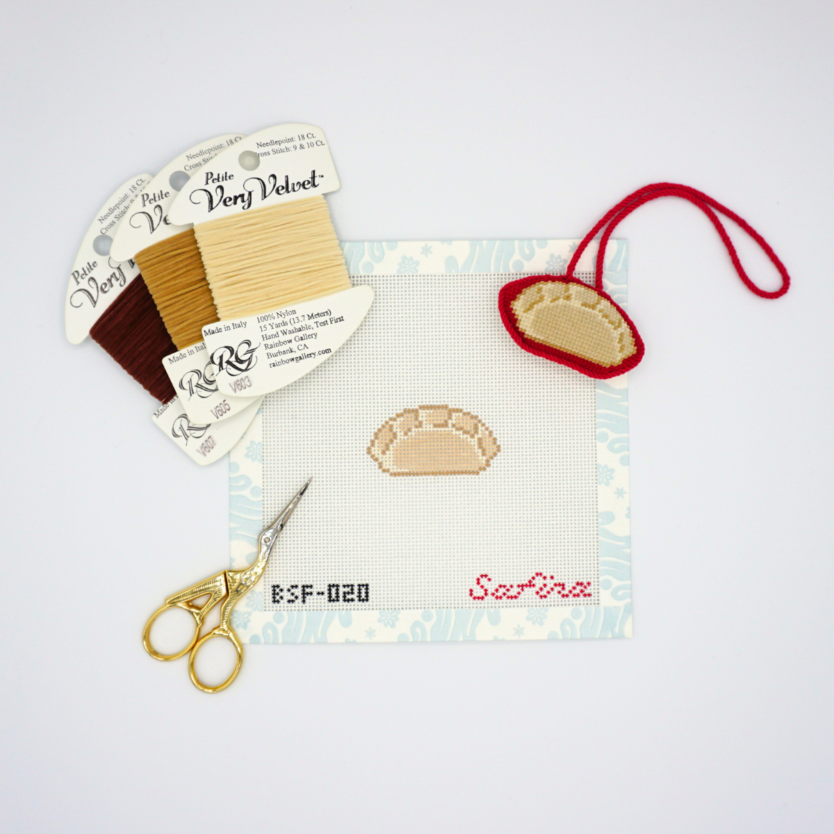 Mini dumpling asian snack needlepoint canvas with fibers, scissors, and finished ornament bag charm