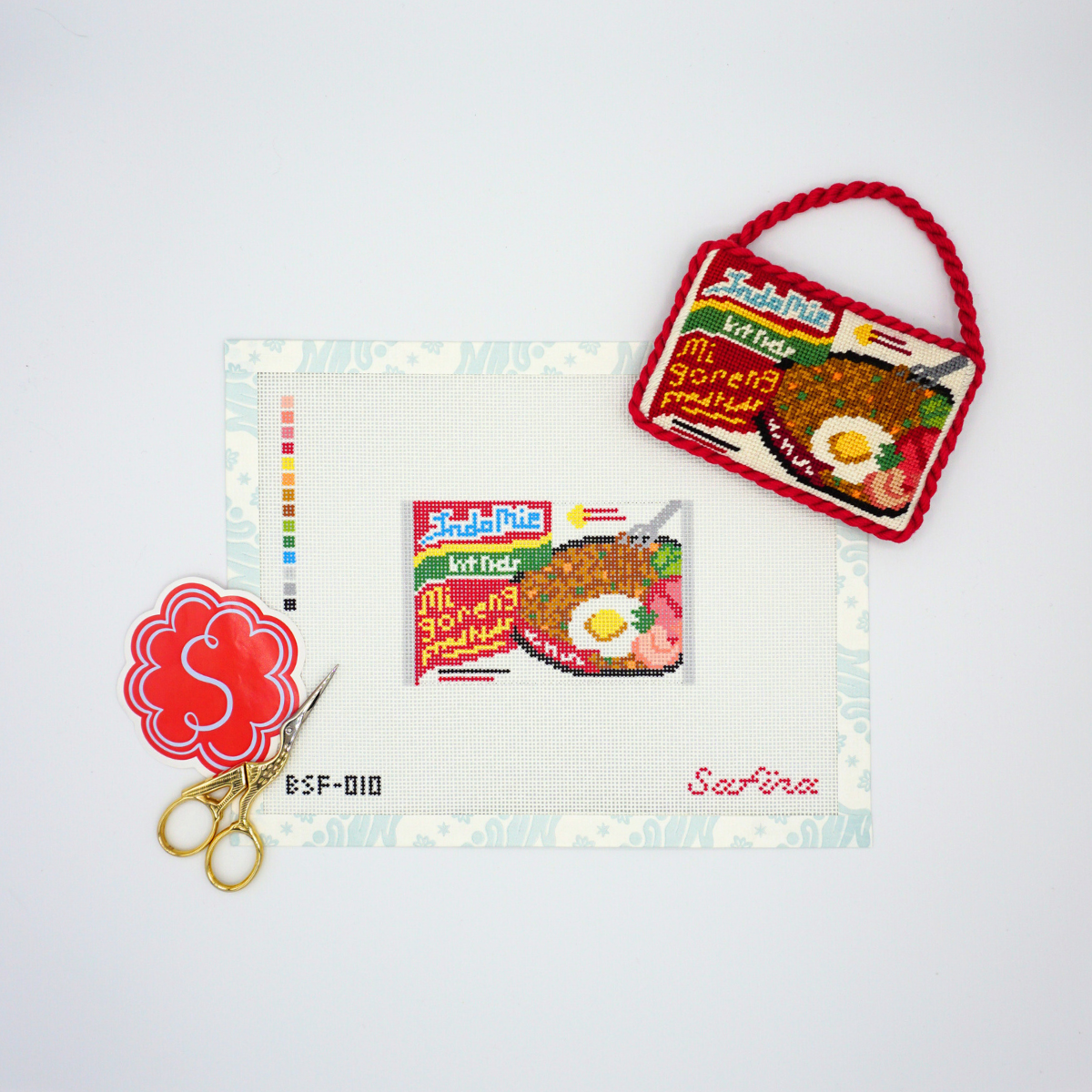Indomie ramen packet Indonesian asian noodle needlepoint canvas with finished ornament, accessories, and scissors