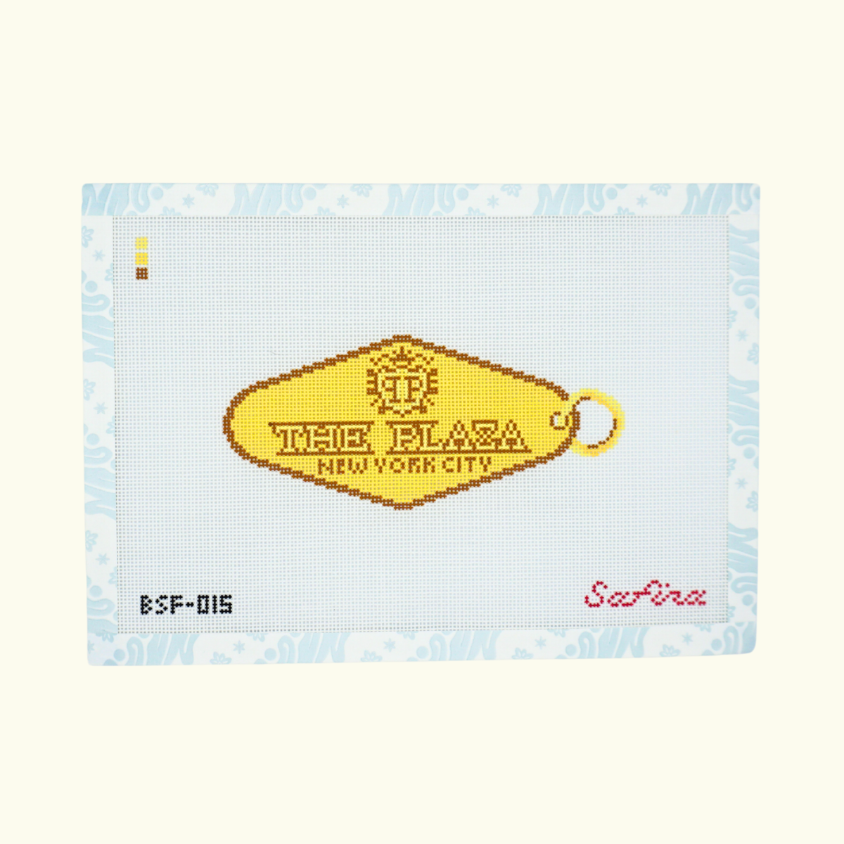 Gold hotel key tag with The Plaza New York City text needlepoint canvas 